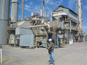 Man with a hardhat and binder conducting an assessment.
