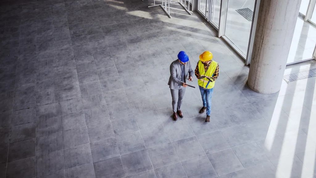 A photo of two industry workers having an environmental safety meeting.